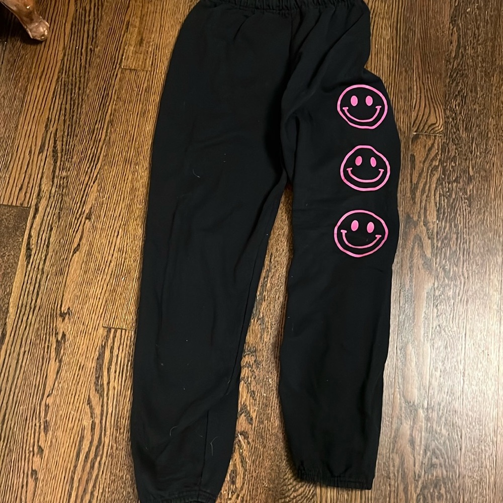 Girls black sweatpants with 3 adorable smiley faces down the left side